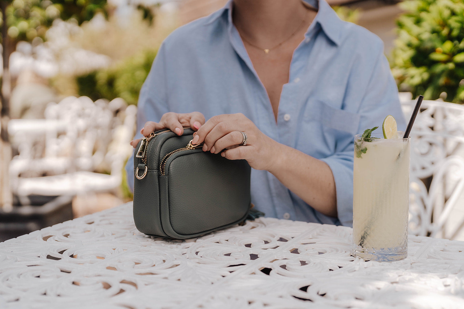Downton Leather Crossbody Bag in Azure Green on table